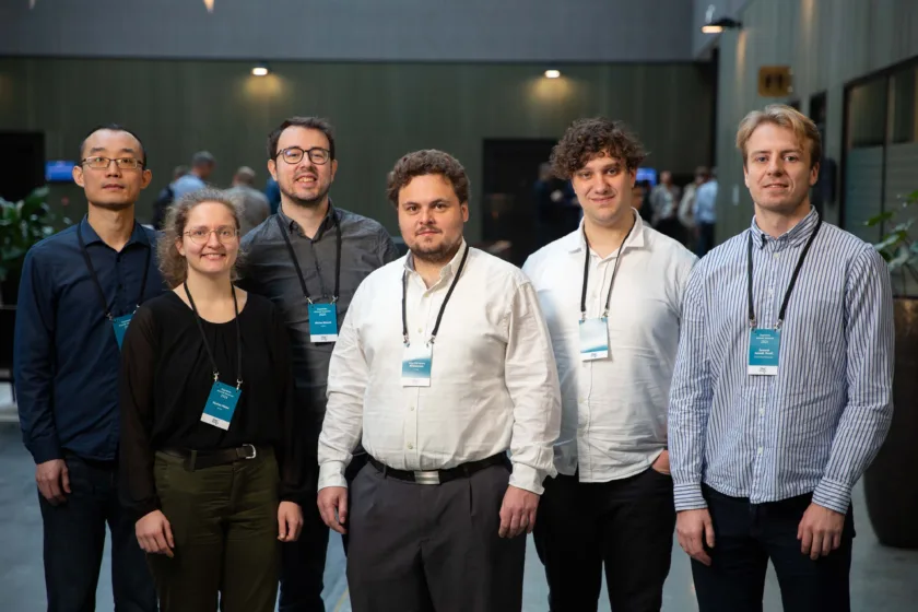 6 persons standing in a lobby area